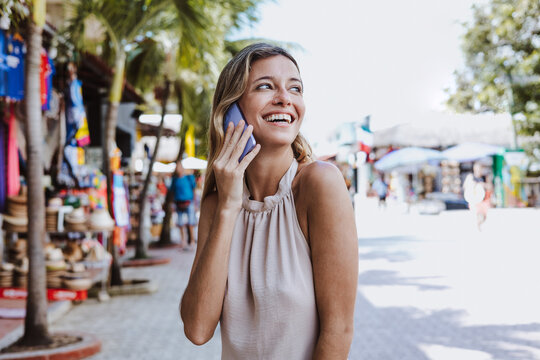 Hispanic Young Woman Talking By Mobile Phone On Vacations Or Holidays In Mexico Latin America, Caribbean And Tropical Destination 