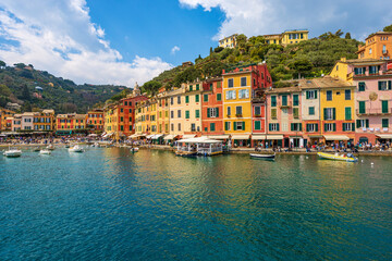 Cityscape and port of Portofino, famous luxury tourist resort in Genoa Province, Liguria, Italy, Europe. Colorful houses, Mediterranean sea (Ligurian sea).