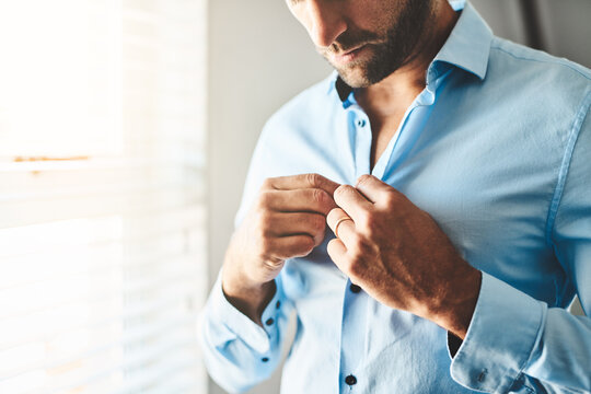 Hands, man and button shirt of clothes for job interview, work event and corporate fashion for business. Closeup, male person and ready in professional outfit from wardrobe in the morning at home