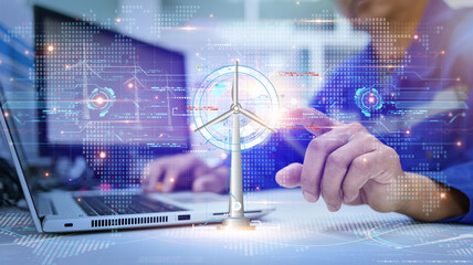 An engineer looks at the power output of a wind turbine generated by a graphical holographic screen...