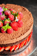 Deliciously moist Chocolate Cake with fresh strawberries and chocolate whipped cream.