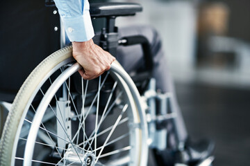 Wheelchair, disability and man hand holding wheel in a hospital for healthcare. Disabled, mobility...