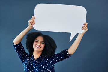 Portrait, speech bubble and woman in studio with banner, news or announcement on blue background. Mockup, poster and happy female face with billboard for social media, advertising or branding launch