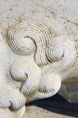 Vintage ornament on the stone. Close-up seamless texture. Stone texture. Embossed pattern.