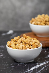 Dried mulberry. Sun-dried mulberry in ceramic bowl. superfood. Vegetarian food concept. healthy snacks. Close up