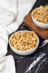 Dried mulberry. Sun-dried mulberry in ceramic bowl. superfood. Vegetarian food concept. healthy snacks