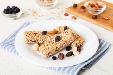 Various granola bars on table background. Cereal granola bars. Superfood breakfast bars with oats, nuts and berries, close up. Superfood concept