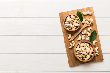 cashew nuts in wooden bowl on table background. top view. Space for text Healthy food