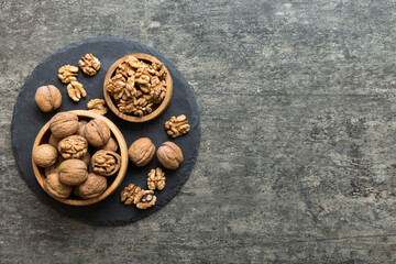 Fresh healthy walnuts in bowl on colored table background. Top view Healthy eating bertholletia concept. Super foods