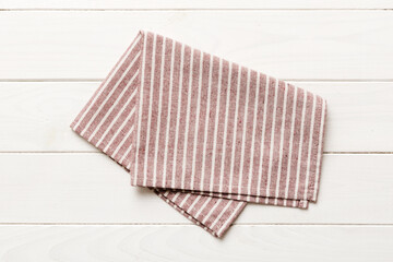 top view with red empty kitchen napkin isolated on table background. Folded cloth for mockup with copy space, Flat lay. Minimal style