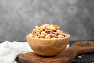 Mixed nuts. Special mixed nuts in a wooden bowl. Nuts, pistachios, peanuts, cashews, almonds. superfood Vegetarian food concept. healthy snacks
