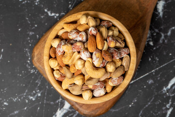 Mixed nuts. Special mixed nuts in a wooden bowl. Nuts, pistachios, peanuts, cashews, almonds. superfood Vegetarian food concept. healthy snacks. Top view