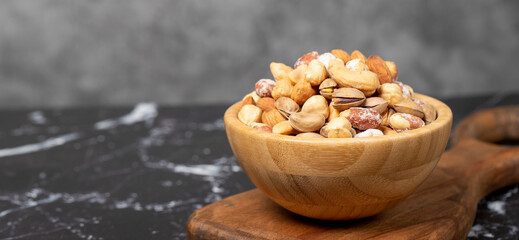 Mixed nuts. Special mixed nuts in a wooden bowl. Nuts, pistachios, peanuts, cashews, almonds. superfood Vegetarian food concept. healthy snacks. Copy space. Empty space for text