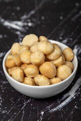 Macadamia nuts. Peeled Macadamia Nuts in a ceramic bowl. superfood. Vegetarian food concept. healthy snacks. Close up