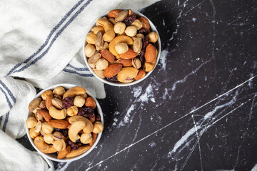 Mixed nuts. Special mixed nuts in a ceramic bowl. Nuts, pistachios, peanuts, cashews, almonds. superfood Vegetarian food concept. healthy snacks. Top view. Copy space. Empty space for text