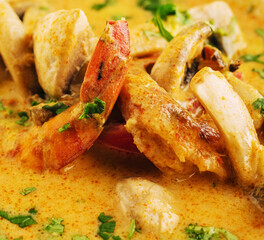 Shrimps tom yam kung in white bowl with thai spices