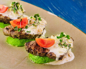 veal on zucchini with mushroom sauce