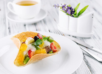 two scoops of natural organic fruit ice cream in a wafer cup