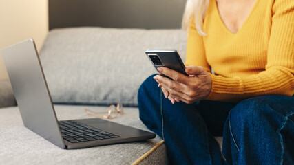 Naklejka premium Woman using technology to stay connected from her home office