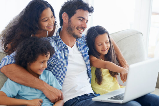 Laptop pointing, hug and dad and children gesture at social media video, online website or kid friendly movies. Together, bonding and happy family kids with father streaming home broadcast film on pc