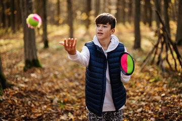 Autumn outdoor portrait of boy play with catch and toss ball game. © AS Photo Family