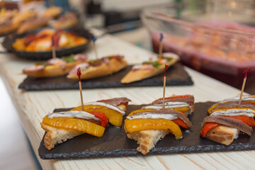 Close up on spanish tapas starters served on a table top. No people are visible. - 603631121