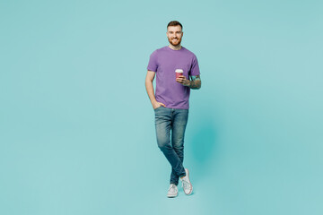 Full body smiling fun young man he wear purple t-shirt hold takeaway delivery craft paper brown cup...
