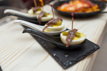 Close up on spanish tapas starters served on a table top. No people are visible. - 603633123