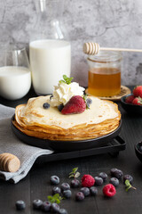 
Fresh pancakes with berries. Breakfast. On a dark background
