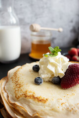 
Fresh pancakes with berries. Breakfast. On a dark background