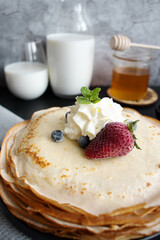 
Fresh pancakes with berries. Breakfast. On a dark background