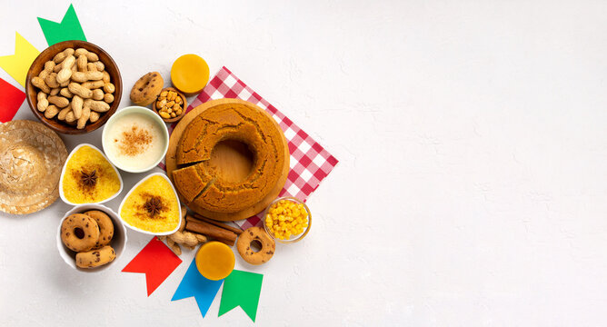 Festa Junina Summer Festival Carnival concept. Brazilian straw hat, popcorn, peanuts and Corn Cake on White Wooden Background