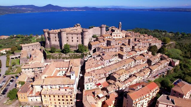 Scenic lake and beautiful medieval castle  Bracciano. Italy. lazio region. Aerial drone view of old town and fortress with lake at background