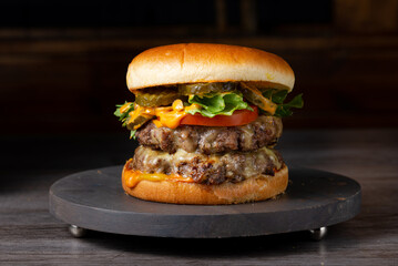 Juicy Delight: Savory Double Beef Burger with Charred Perfection, Topped with Gourmet Condiments and Fresh Ingredients for a Classic Grilling Experience