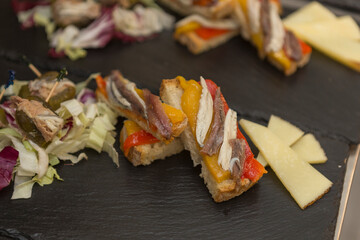 Close up on spanish tapas starters served on a table top. No people are visible. - 603642126