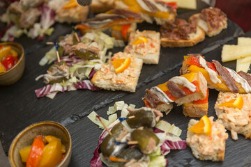 Close up on spanish tapas starters served on a table top. No people are visible.