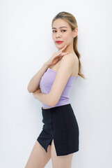 Naklejka premium Portrait isolated cutout closeup shot of millennial Asian young beautiful sexy long hair model in seamless tube cropped top standing posing crossed arms look at camera on white background copy space