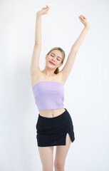 Portrait studio isolated cutout shot of Millennial Asian beautiful pretty cheerful female model in tube cropped top casual shirt holding hands up closed eyes stretching arms on white background