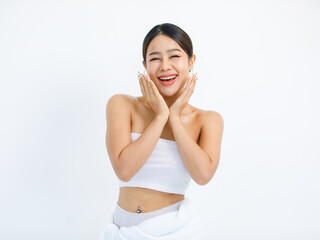 Isolated cutout studio shot millennial Asian beautiful pretty sexy female model in tube cropped top shirt standing smiling holding hand on face showing presenting painting nails on white background