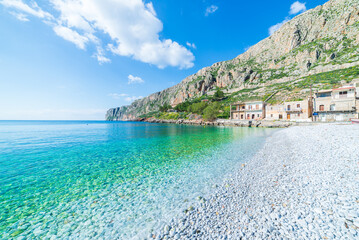 Beautiful beach and water bay in the greek spectacular coast line. Turquoise blue transparent water white pebbles, Greece summer top travel destination, Mani peninsula, Peloponnese