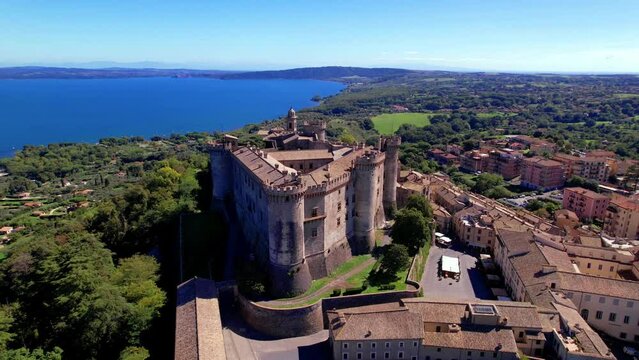 Scenic lake and beautiful medieval castle  Bracciano. Italy. lazio region. Aerial drone view of old town and fortress with lake at background