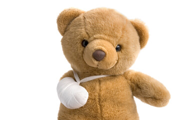 Toy teddy bear with a broken leg close up on white background