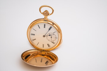 Fototapeta na wymiar vintage gold pocket watch longines isolated on white background, pocket watch on books background