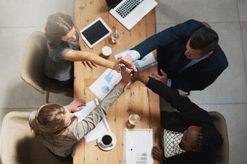 People, high five and business meeting success at table with documents above for teamwork at...
