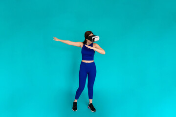 Woman with vr glasses simulating using bow and arrow.