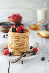 Pancakes with berries in rustic style