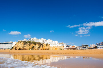 Great view of Fisherman Beach, Praia dos Pescadores, with whitewashed houses on cliff, Albufeira, Algarve, Portugal