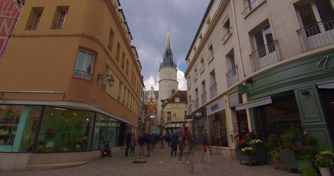 Establishing shot time lapse. Beautiful street with old traditional French houses in the center of Auxerre with clouds in the background. Legacy of French history. Colorful houses in France