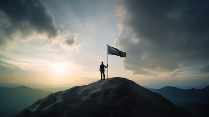 A silhouette of a successful businessman holding a large flag stands on top of a mountain in the morning sunlight, featuring his success - obrazy, fototapety, plakaty