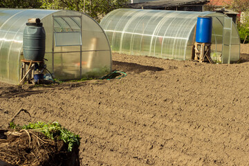 Beautiful vegetable garden with greenhouses potato beds and black soil great design for any purposes Home backyard